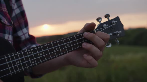 The Moves of Man's Hands on the Guitar's Stripes