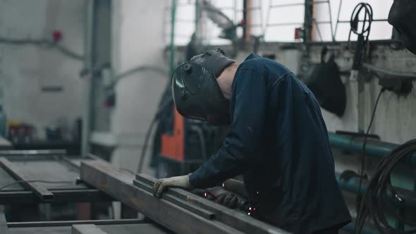 A Working Welder Connects Metal Parts By Gas or Electric Welding in Slow Motion
