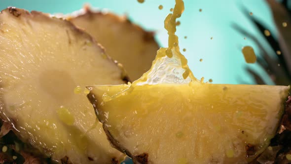 Slow Motion Shot of Pineapple and Juice Splashing Through Pineapple Slices