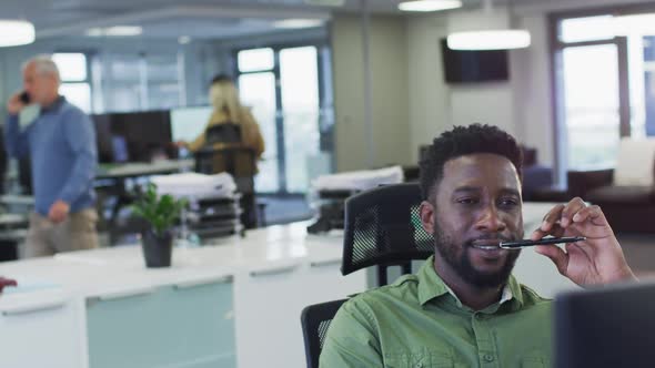 Thoughtful man sitting on his desk at office