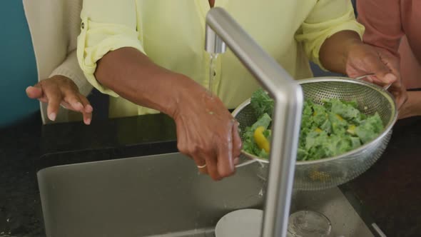 Senior diverse people cooking in kitchen at retirement home