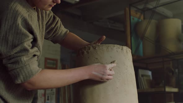 Woman Potter Is Scraping Vase of Raw Clay