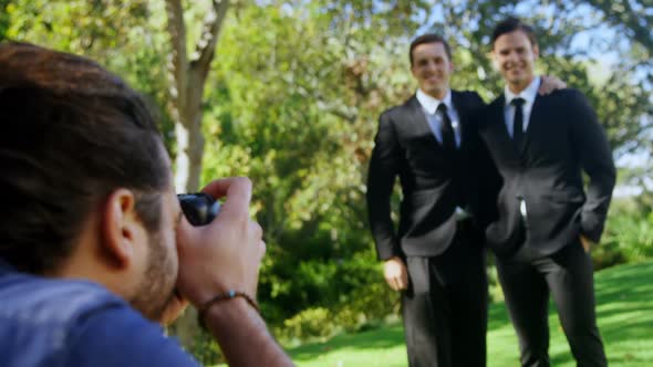 Photographer taking photo of groomsmen 4K 4k