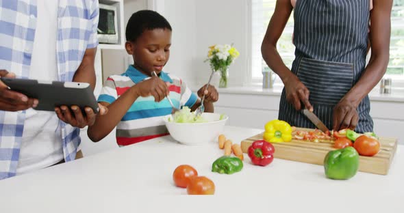 Happy family preparing food in kitchen