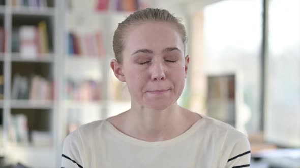 Portrait of Crying Young Woman Looking at Camera