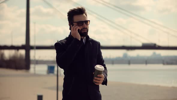 Businessman Using Mobile Phone.Businessman Talking On Mobile Phone With Colleague.Remote Working