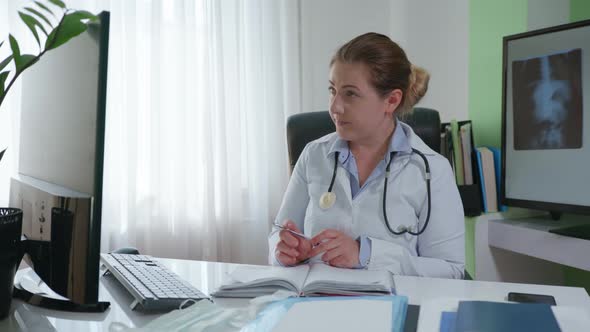 Consultation Online, Female Doctor Communicates with Sick Patient Via Video Communication and Writes