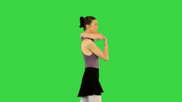 Young Ballerina in Training Clothes Walks Warming Up on a Green Screen Chroma Key