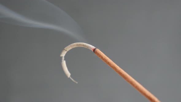 Burned  fragrant incense stick smoke spreading 4K 2160p 30fps UltraHD footage - Close-up of aromatic