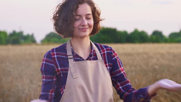 Portrait Of Happy And Smiling Farmer In Apron On Wheat Field. Girl Having Fun With Flour, Organic