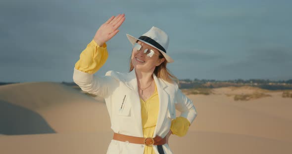 Fashionable Woman Is Looking on the Sun Through Her Fingertips. Safari Travel