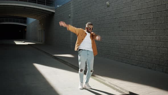 Looping of Cheerful African American Person Dancing Waving Arms Outdoors on Sunny Day