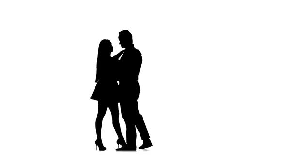 Loving Couple Is Dancing Latin Dances in the Studio. Silhouette. White Background. Slow Motion