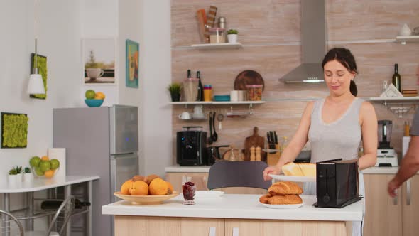 Woman Using Toaster