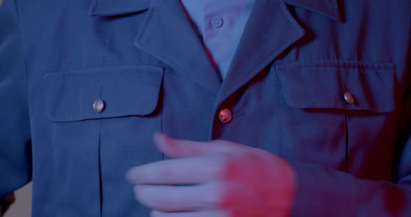 Closeup of a Man's Hands Laying Uniform on Body Rubbing the Pellets and Dust