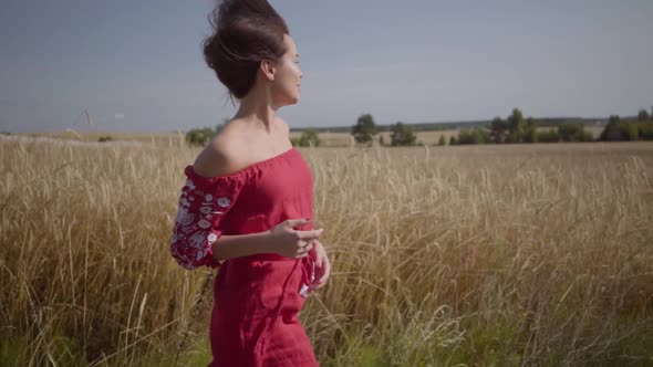 Side View of Beautiful Carefree Woman with Long Hair Running Through the Wheat Field, Hair