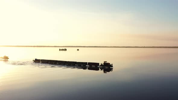 An Old Train Travels on a Railway Laid in the Water Across a Salt Lake. Aerial View. Extraction of