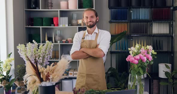Portrait of Smiling Male Florist Crossing Arms and Looking at camera.