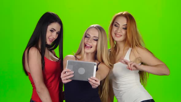 Girls Pose for the Camera of the Tablet