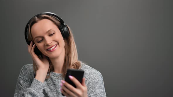 Joyful Lady Wearing Headphones Listening Music Use Smartphone