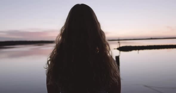 Woman At Sunset Looking Out Over Harbour