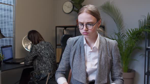 Young Unhappy Secretary Girl Irritated Sad Angry Mad After Analyzing Financial Papers in Office
