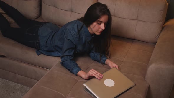 Smiling Woman Lying on Couch Started Working on Laptop Typing Message Lady Chatting on Computer