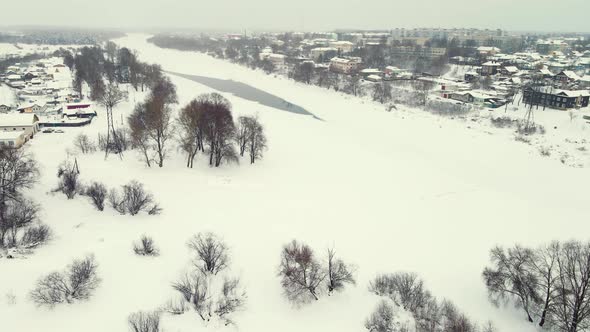 Fabulous Winter Landscape Aerial View Frozen River and a Town on the Shore