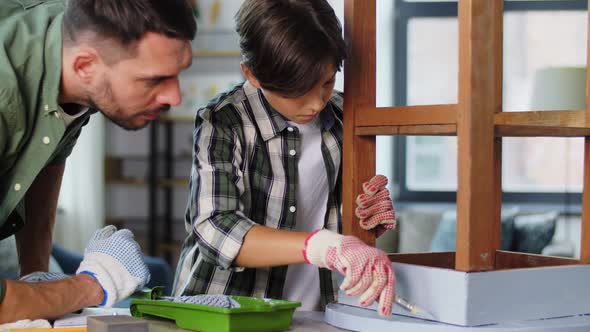 Father and Son Painting Old Table in Grey Color
