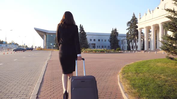 Unrecognizable Business Woman with Suitcase Walks to the Airport to Go on Business Trip