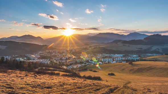 Colorful Sunset Sky with Beautiful Sunbeam Light of Sun over Small Europe City Landscape