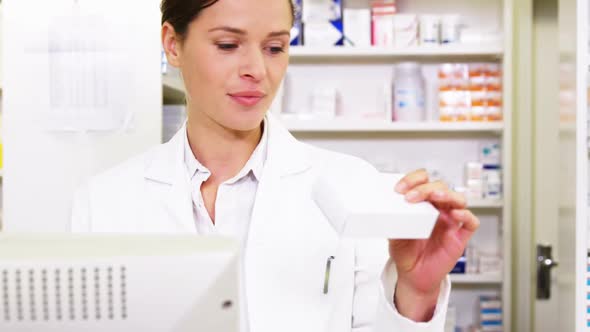 Pharmacist holding prescription paper while talking on phone