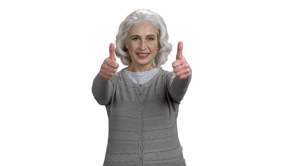 Smiling Mature Woman Giving Two Thumbs Up