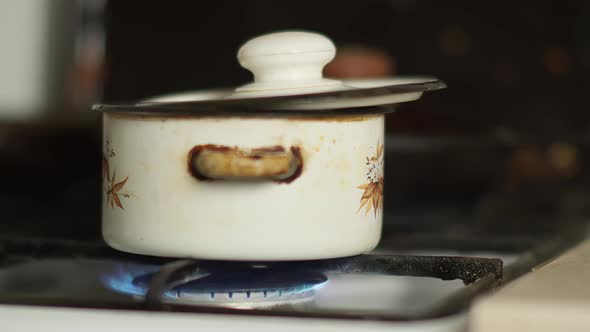 Pan Is on the Stove with the Gas Turned On, Camera Is Moving