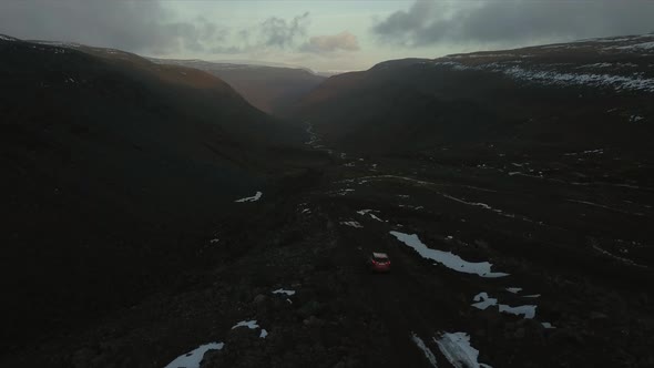 Car driving through snowy hills