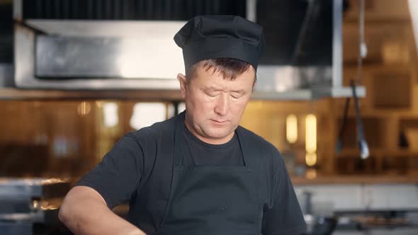 Portrait of Asian Chef Cooking Food Mix in Pan on Stove