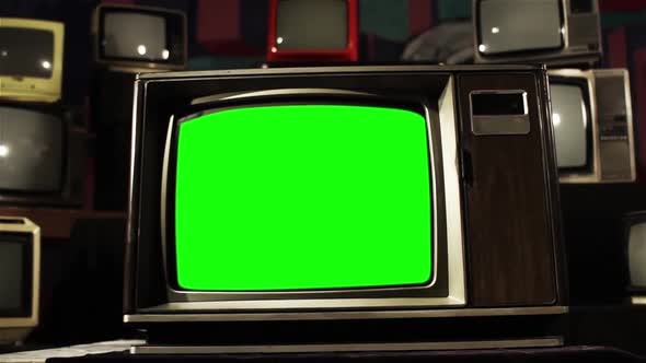 Old TV Green Screen in the Middle of Many TVs. Aesthetics of the 80s.