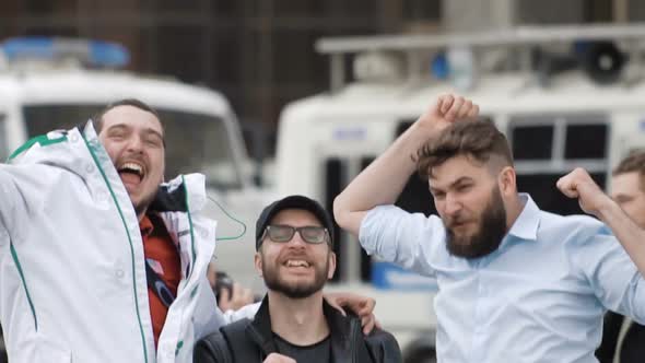 Football Fans Looking at the Camera Jumping and Smiling in Slow Motion Close Up