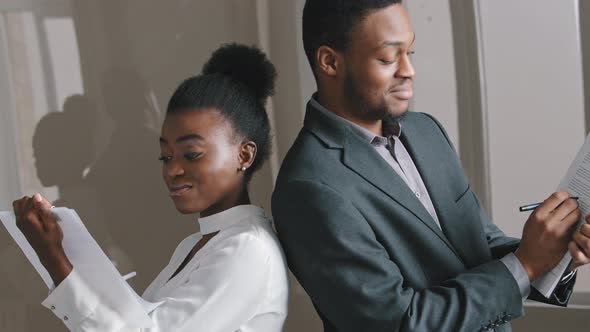 Young African American Students Interns or Diverse Business Partners Standing Backs Turned in Office