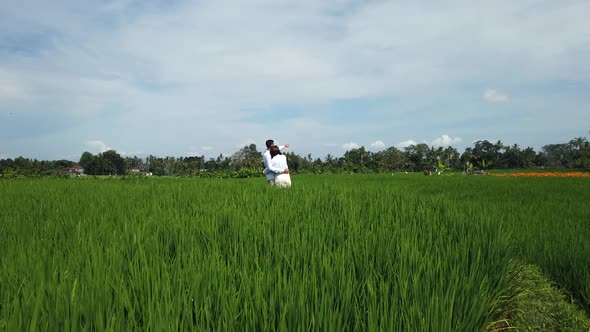 Beautiful family couple looking on rice terraces, Bali, Indonesia. Romantic love story on nature