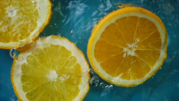 Sliced Orange Plunging and Splashes in Water