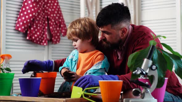 Father and Son Gardening Plant in Pots