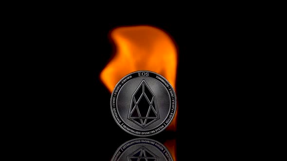 EOS Coin Catches Fire on an Isolated Black Background
