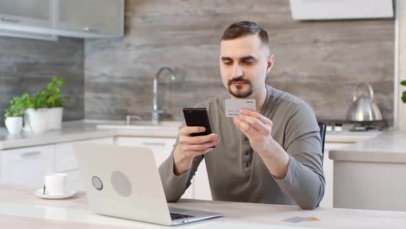 Man Paying with Credit Card via Smartphone