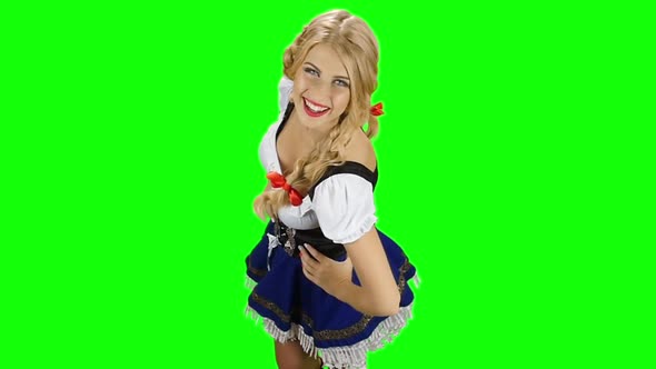 Girl in Bavarian Costume Dancing and Laughing. Slow Motion. Green Screen