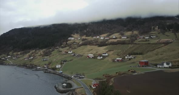 Aerial shot of Cars passing through Utvik village, Cloudy, Norway