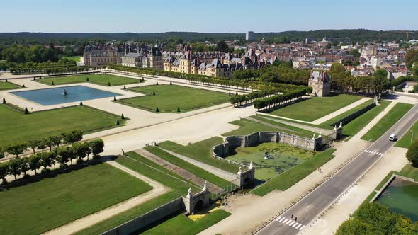 Aerial View of Medieval Landmark Royal Hunting Castle Fontainbleau and Lake with White Swans, France