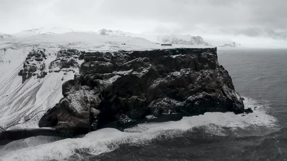 Aerial View of Black Sand Beach in Cloudy Weather. The Beginning of Spring in Iceland