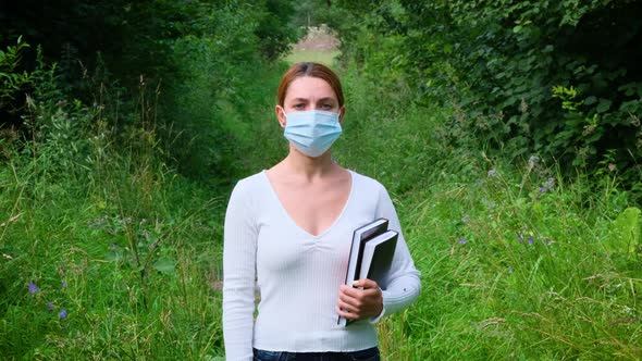 Portrait Young Woman Stands Alone in Park in Mask. Safety, Distance, Health