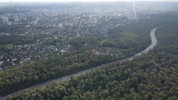 Megalopolis Next To the Forest: the Contact Between the Big City and Nature. Aerial View. Slow